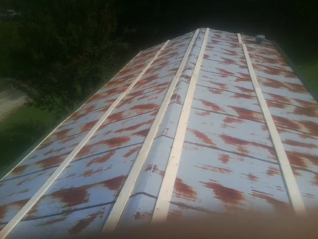 Rusted metal roof panels with new wood purlins before replacement — Storm Damage Roof Repair in Greenview by Roofing Brothers